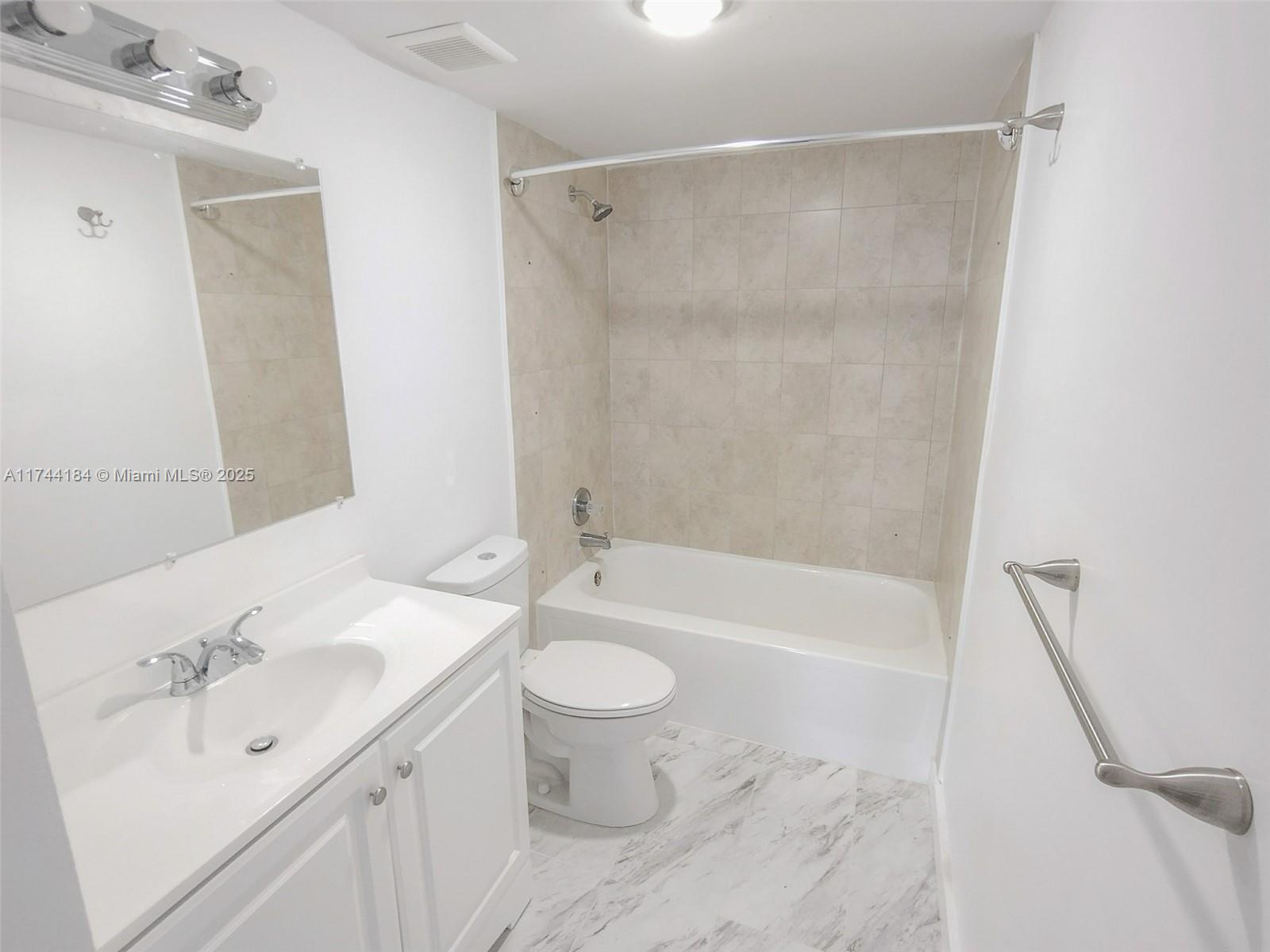 4174 Inverrary Drive, Unit 706 Lauderhill, FL 33319 - Photo 21 of 59 a bathroom with a sink toilet and shower