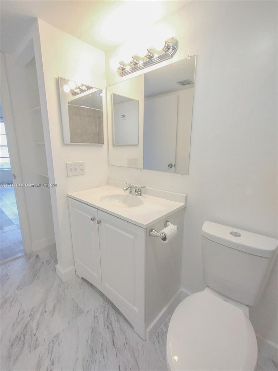 4174 Inverrary Drive, Unit 706 Lauderhill, FL 33319 - Photo 28 of 59 a bathroom with a sink toilet and mirror