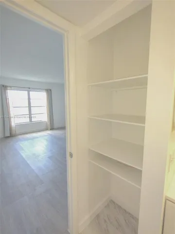 a view of a porch with wooden floor and front door