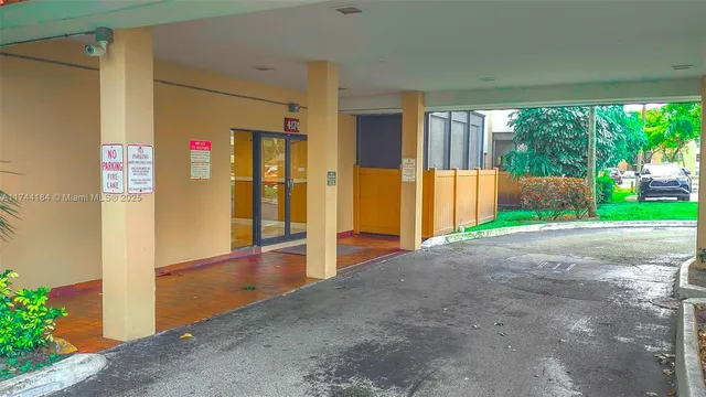 a view of a swimming pool with a patio and a garden