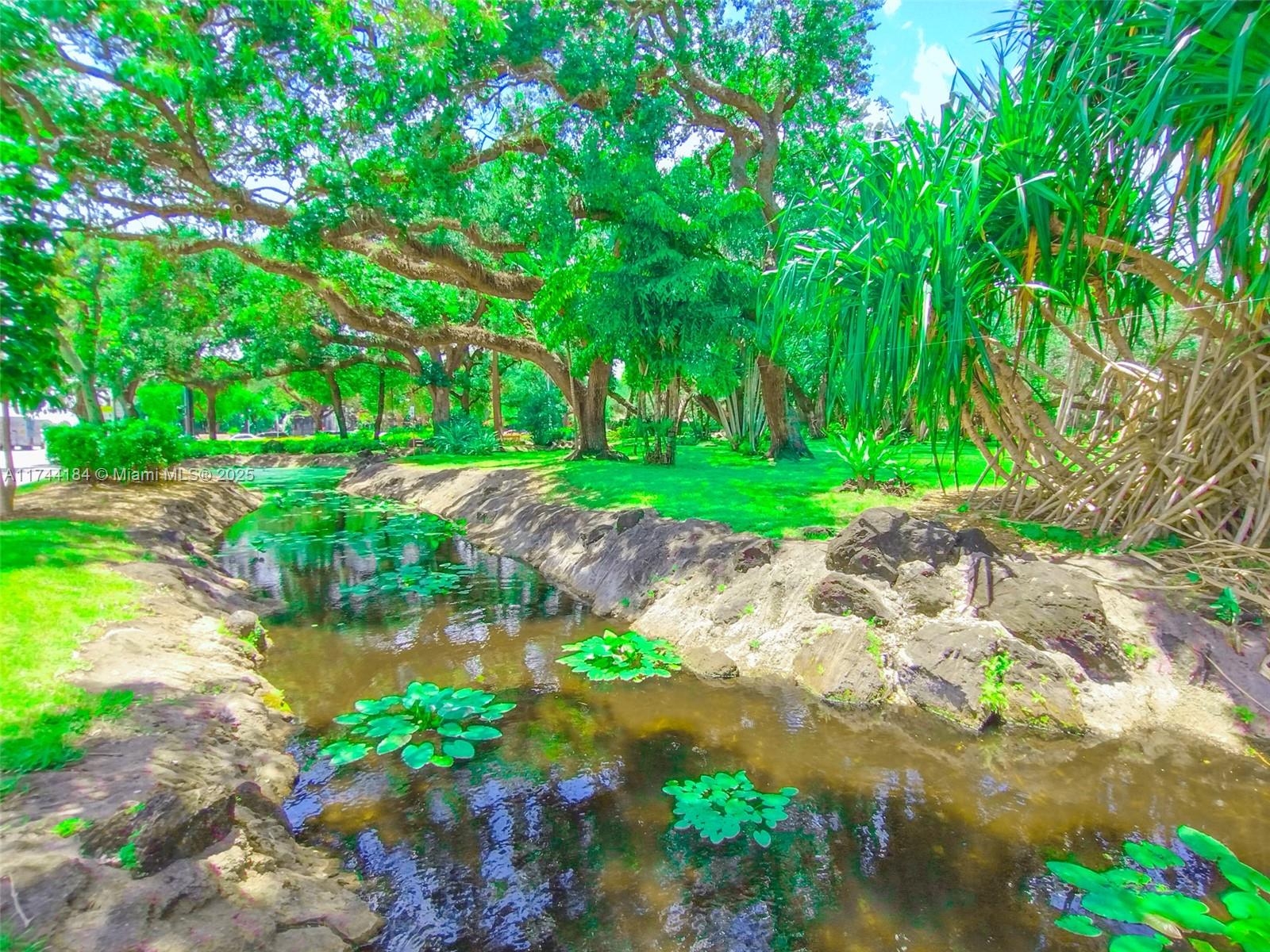 4174 Inverrary Drive, Unit 706 Lauderhill, FL 33319 - Photo 45 of 59 a backyard of a house with a garden and plants