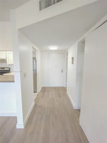 a view of a kitchen from the hallway