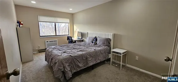 a bed sitting in a room next to a window