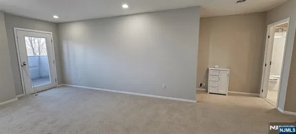 an empty room with windows and closet