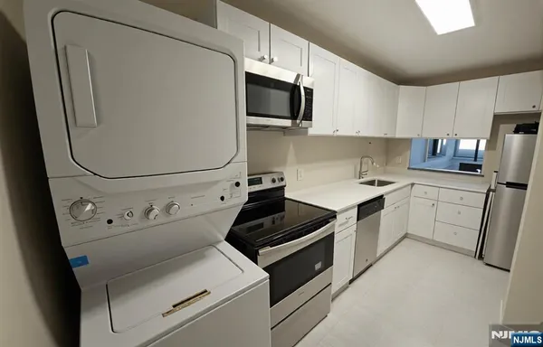 a kitchen with cabinets and steel appliances