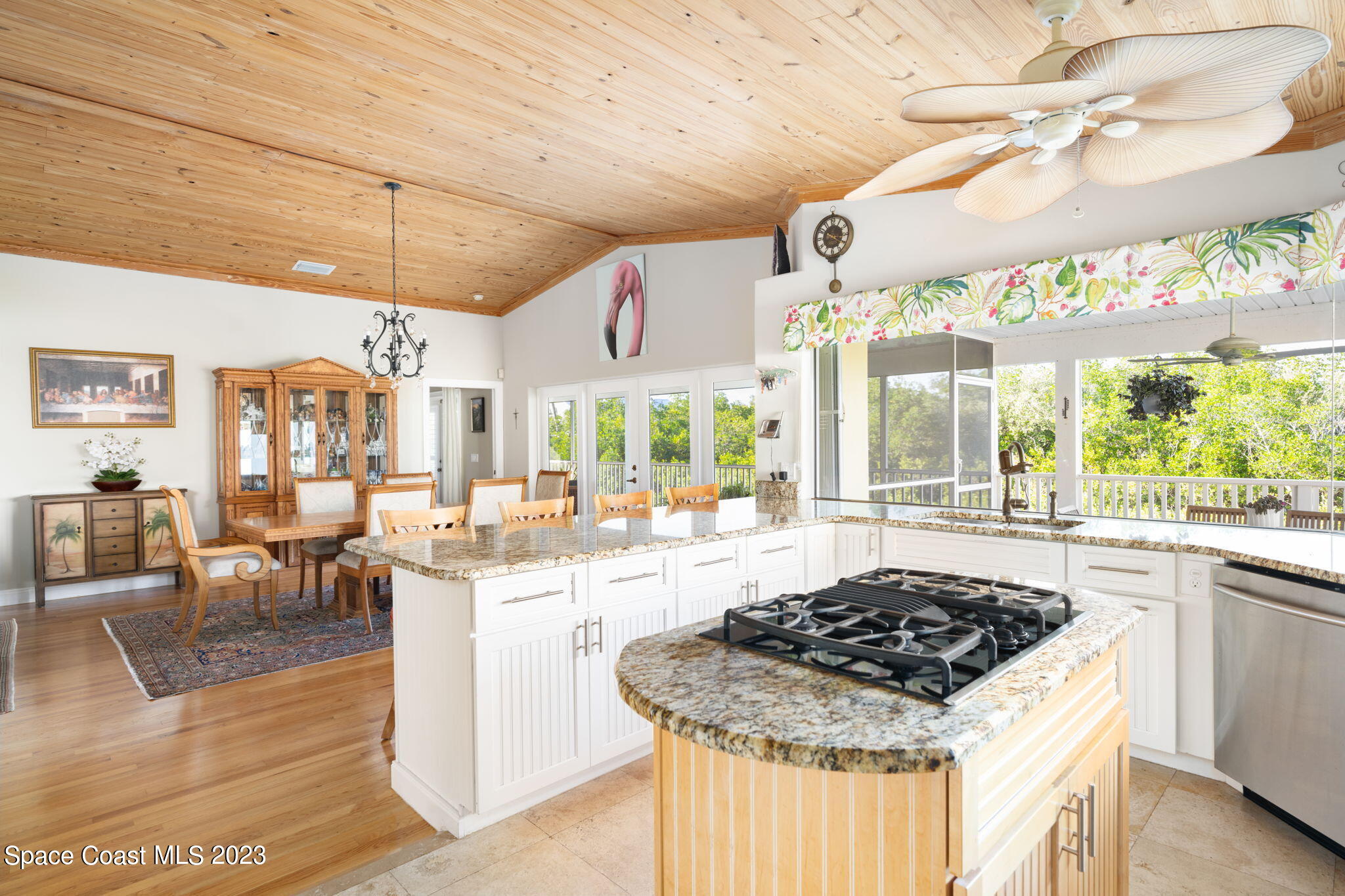 5280 95th Street Sebastian, FL 32958 - Photo 11 of 42 a kitchen with a stove a sink a refrigerator cabinets and dining table