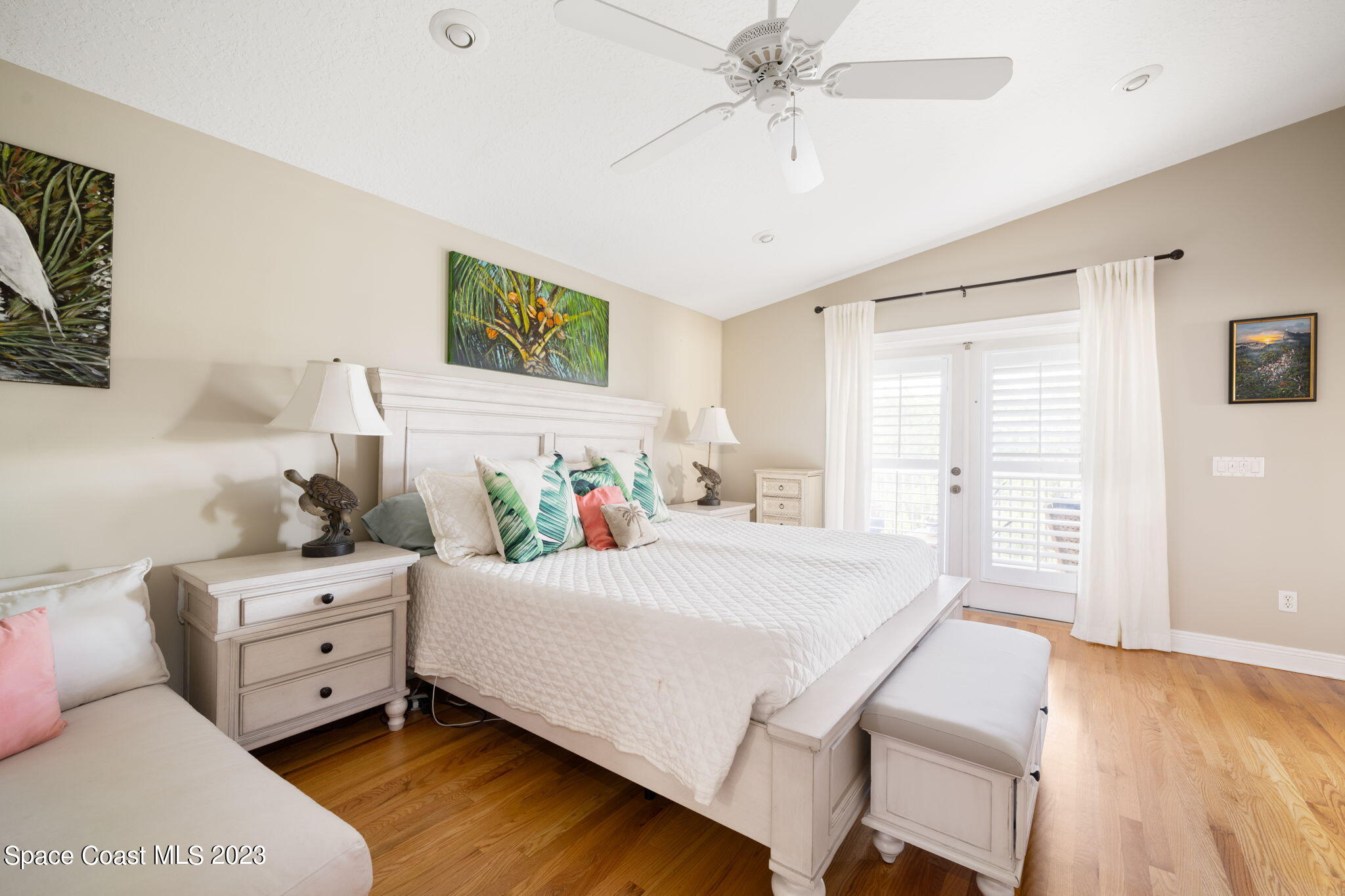 5280 95th Street Sebastian, FL 32958 - Photo 16 of 42 a bedroom with a bed and a chandelier