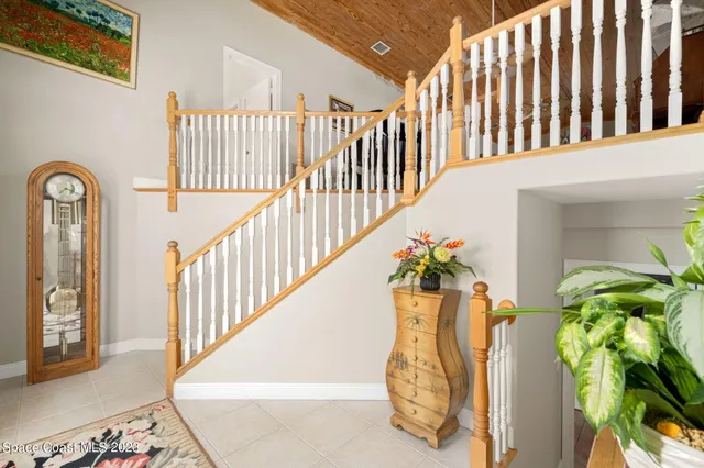 a view of staircase with railing and a flower pot