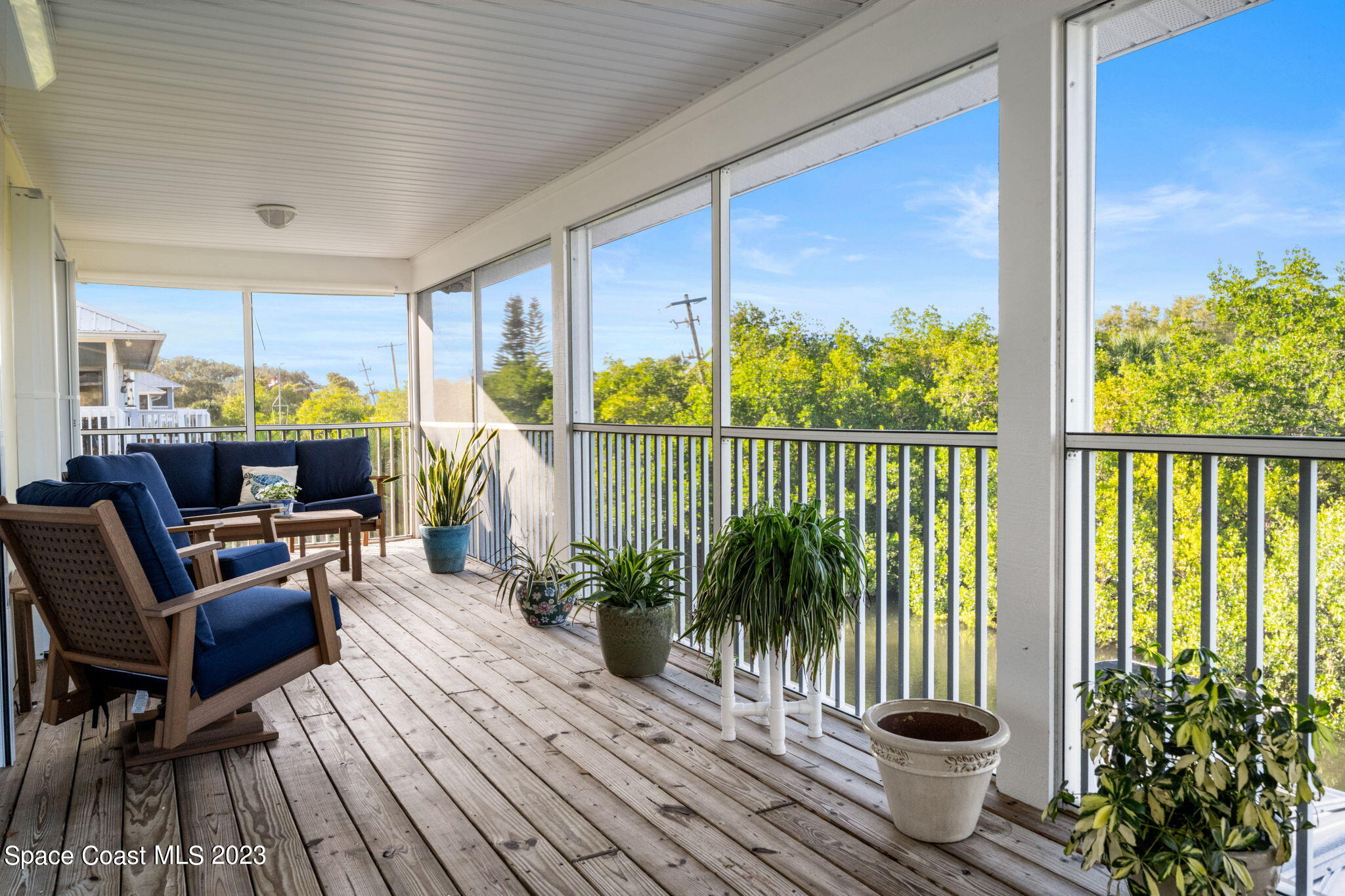 5280 95th Street Sebastian, FL 32958 - Photo 21 of 42 a living room with furniture floor to ceiling window and wooden floor