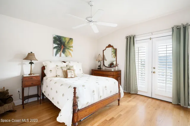 a bedroom with a bed table and a window
