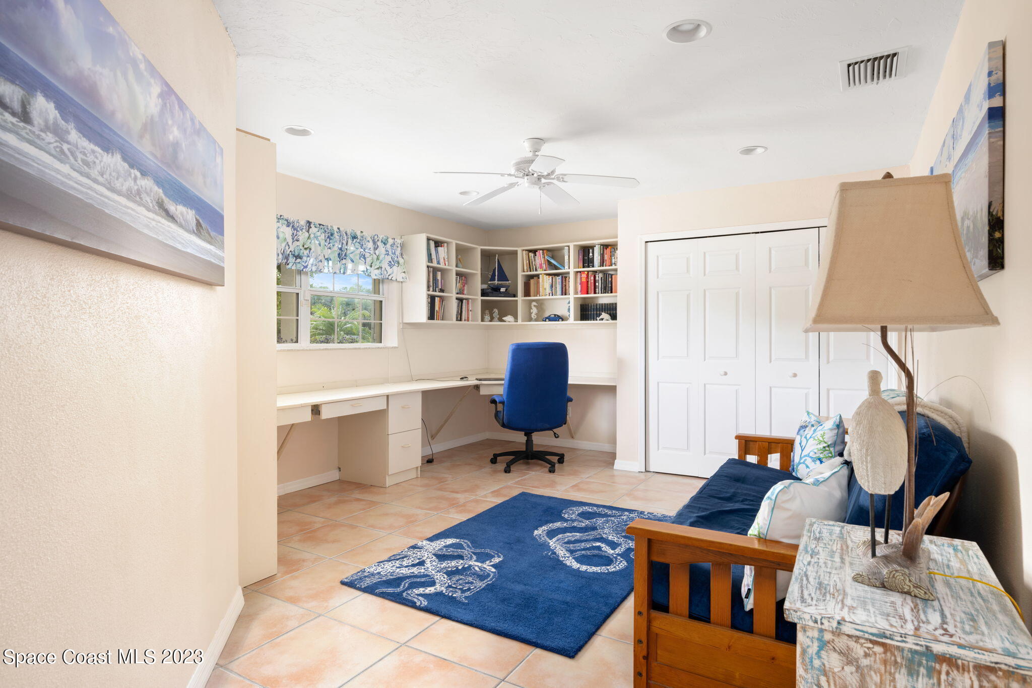 5280 95th Street Sebastian, FL 32958 - Photo 30 of 42 a living room with furniture a rug and a chandelier