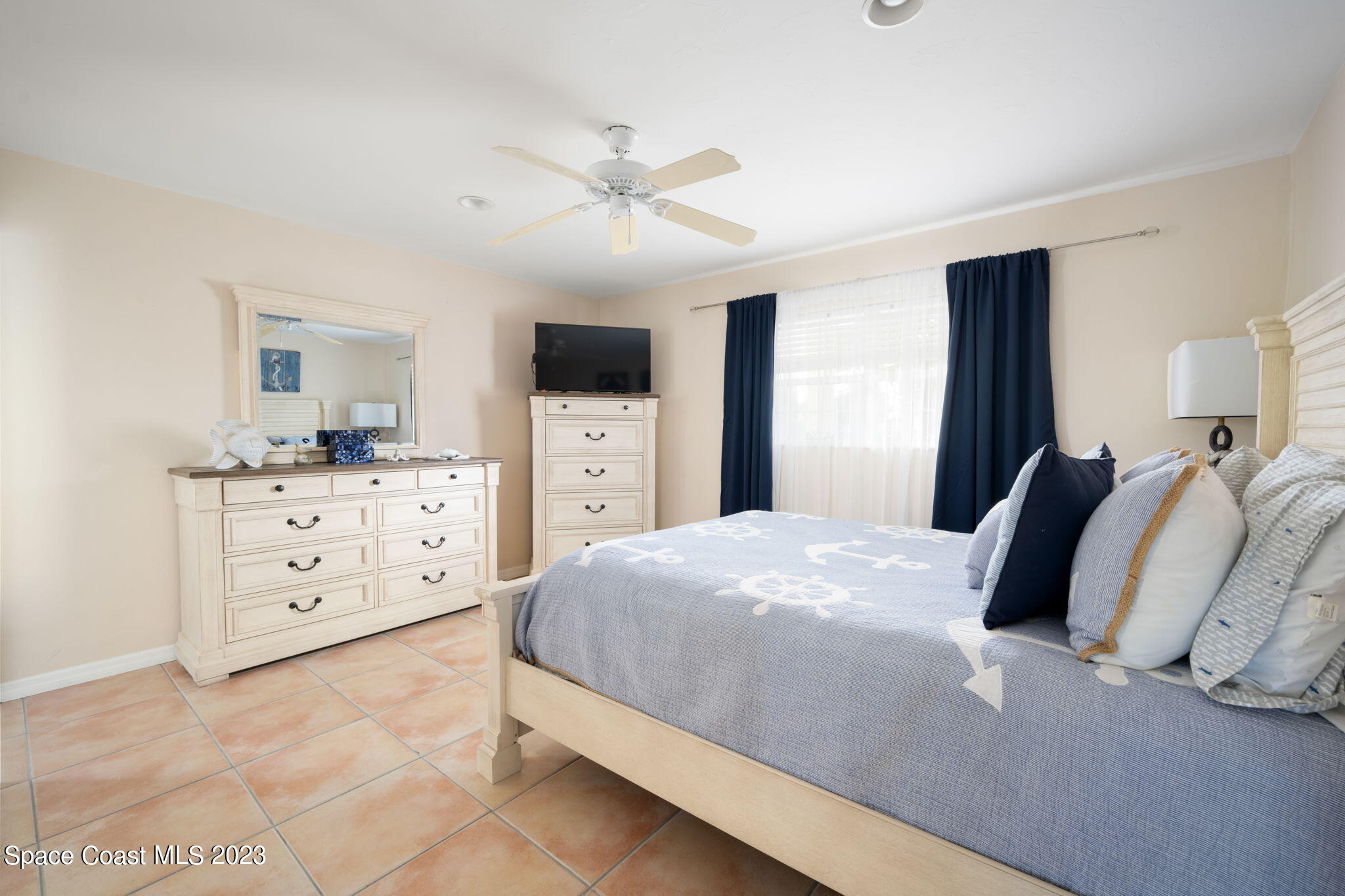 5280 95th Street Sebastian, FL 32958 - Photo 32 of 42 a bedroom with a bed and a dresser