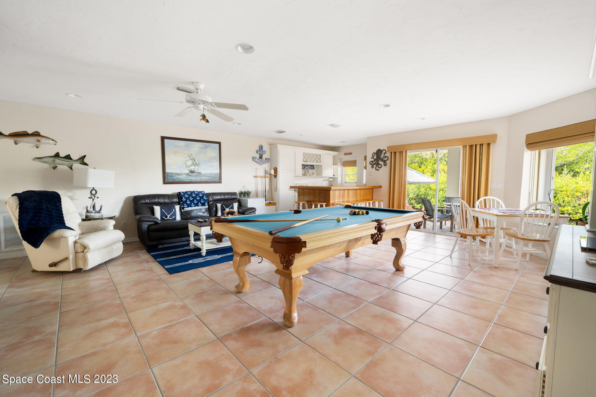 5280 95th Street Sebastian, FL 32958 - Photo 35 of 42 a living room with furniture a fireplace and a large window