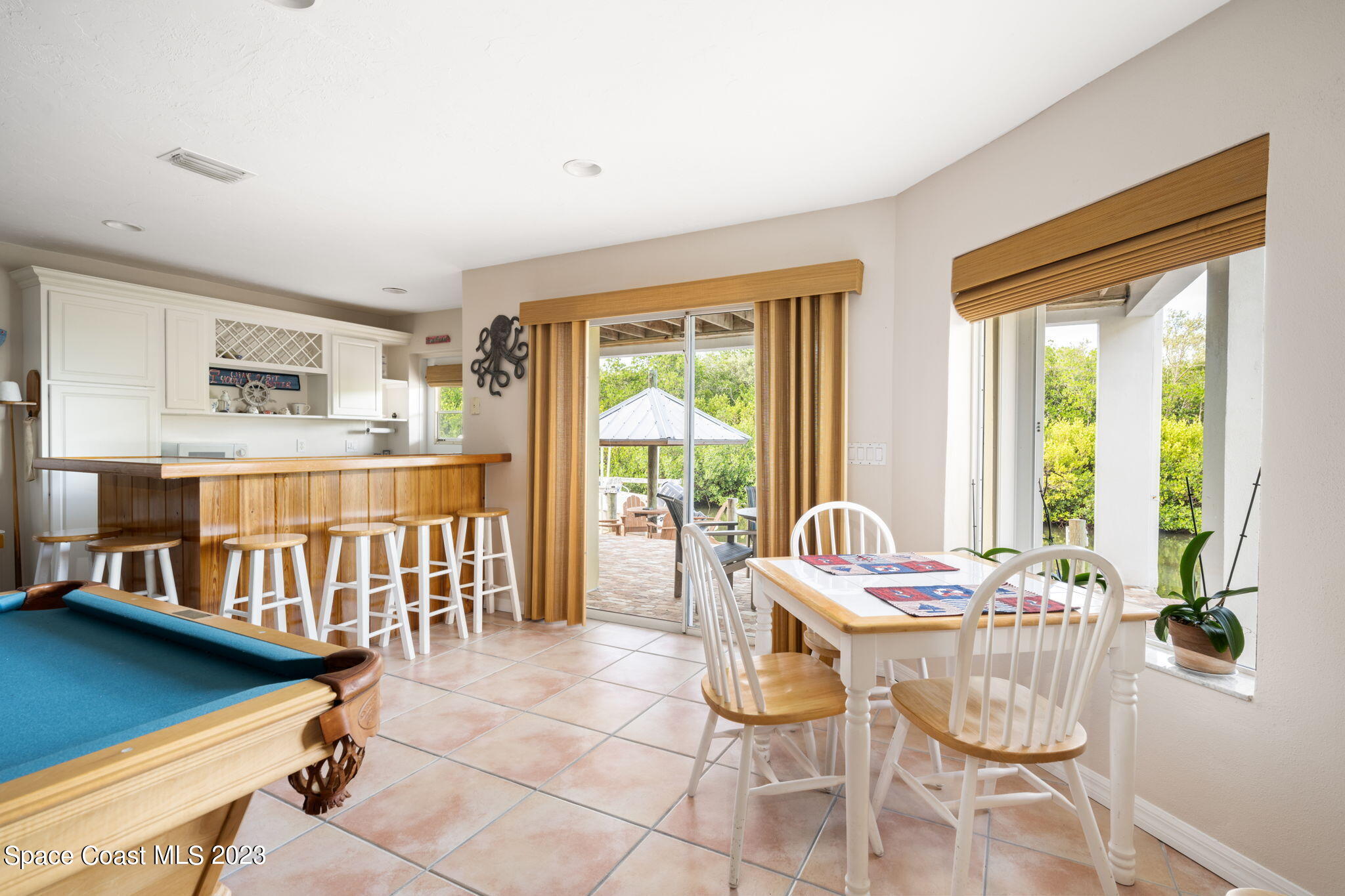 5280 95th Street Sebastian, FL 32958 - Photo 37 of 42 a dining room with furniture and large windows