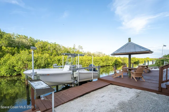a view of a patio with chairs and backyard