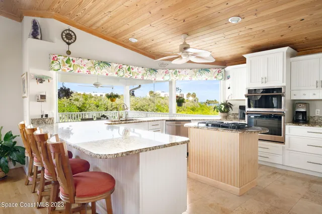 a kitchen with a table chairs stove and kitchen view