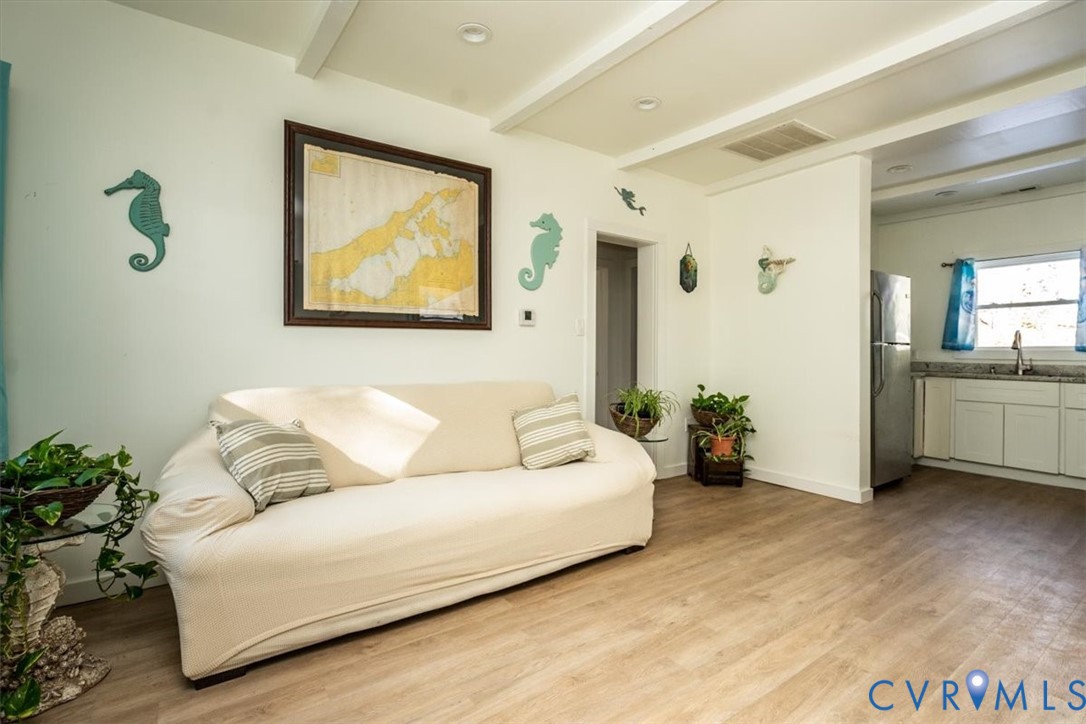 611 Jones Point Beach Road Laneview, VA 22504 - Photo 15 of 27 Living room with wood finished floors, a wood stov