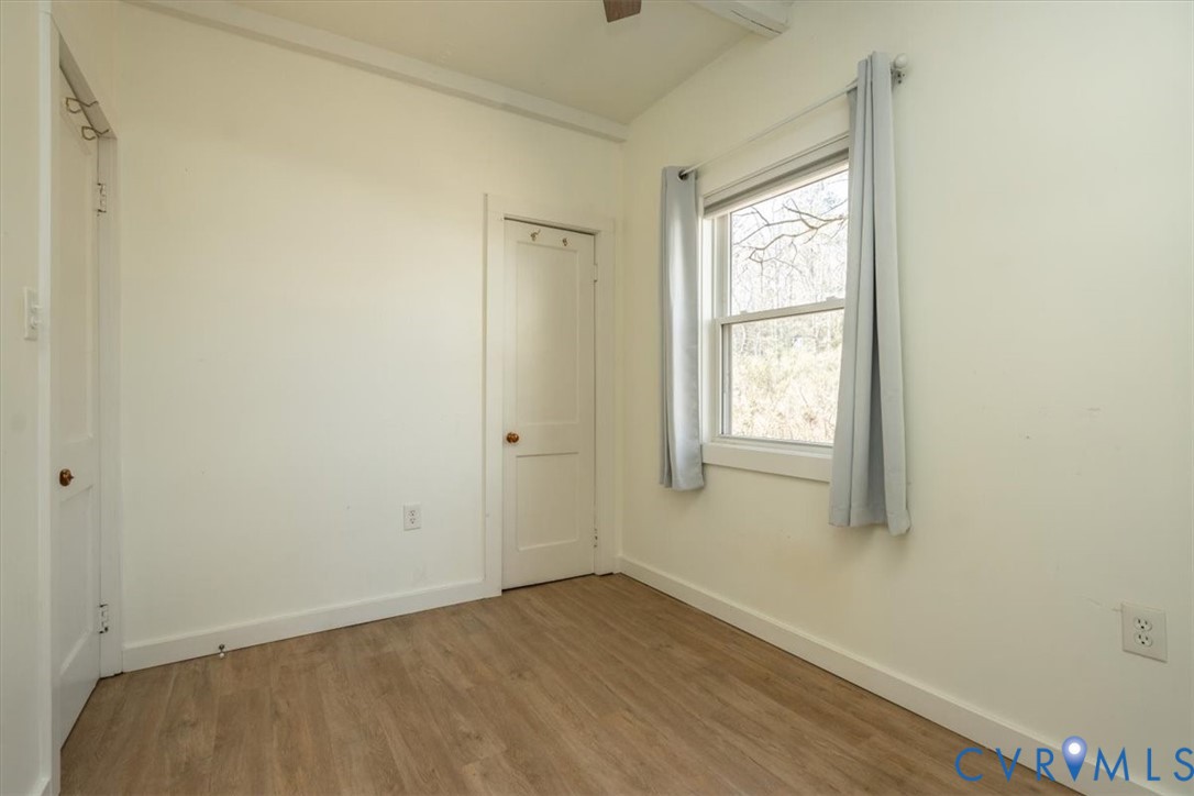 611 Jones Point Beach Road Laneview, VA 22504 - Photo 23 of 27 a view of an empty room with wooden floor and a window