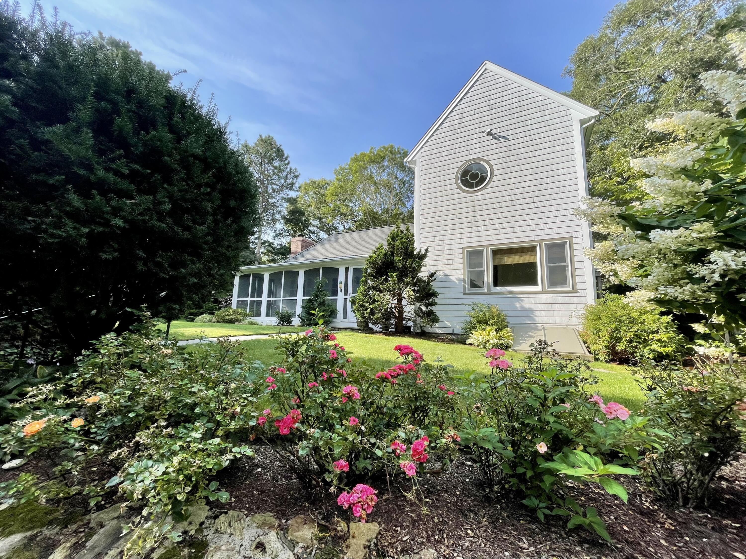 100 Bay Lane Centerville, MA 02632 - Photo 1 of 32 a front view of a house with a yard and potted plants