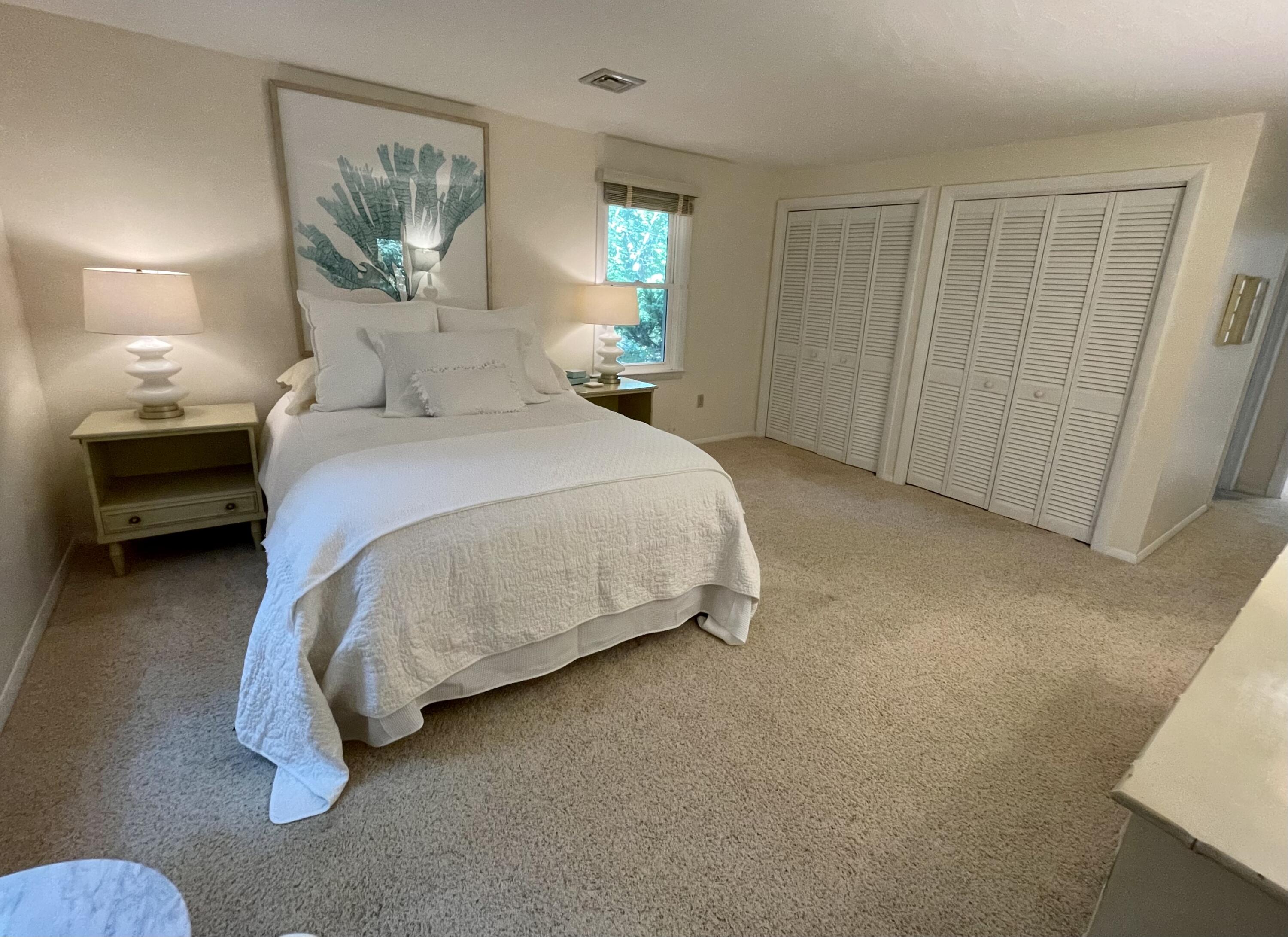 100 Bay Lane Centerville, MA 02632 - Photo 13 of 32 a bedroom with a bed and a mirror