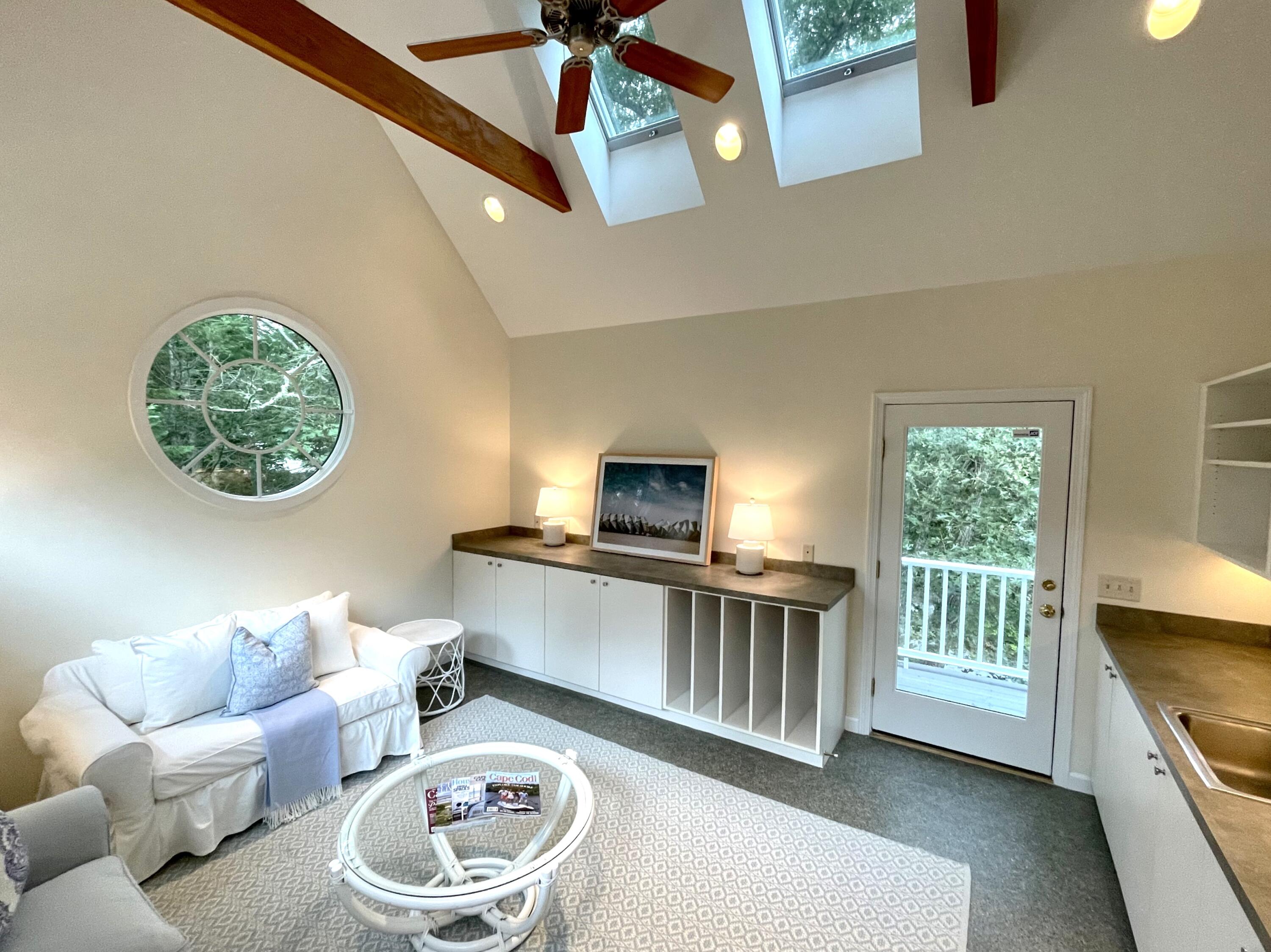 100 Bay Lane Centerville, MA 02632 - Photo 18 of 32 a living room with furniture a window and a flat screen tv