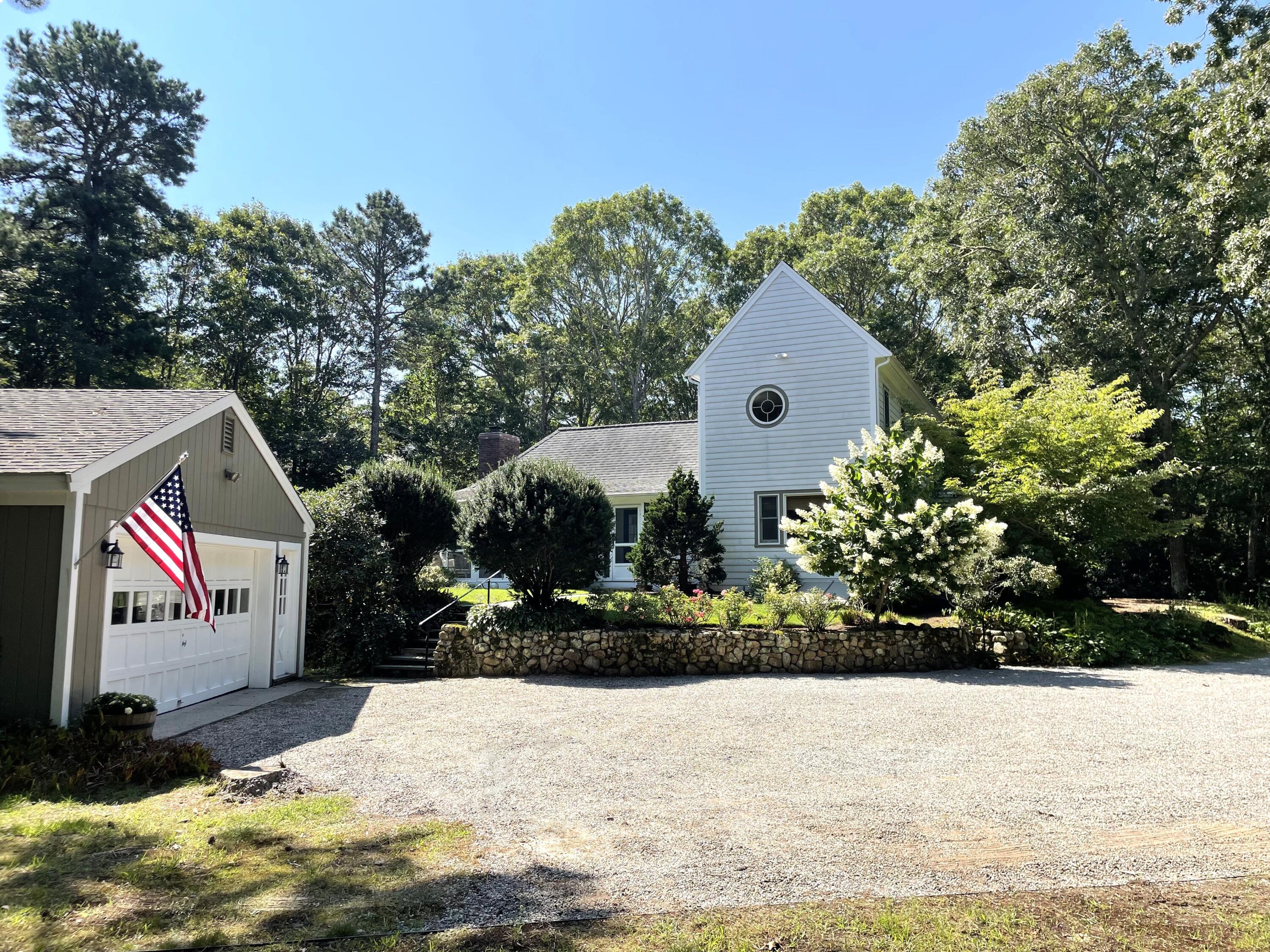 100 Bay Lane Centerville, MA 02632 - Photo 2 of 32 a front view of a house with a yard and garage