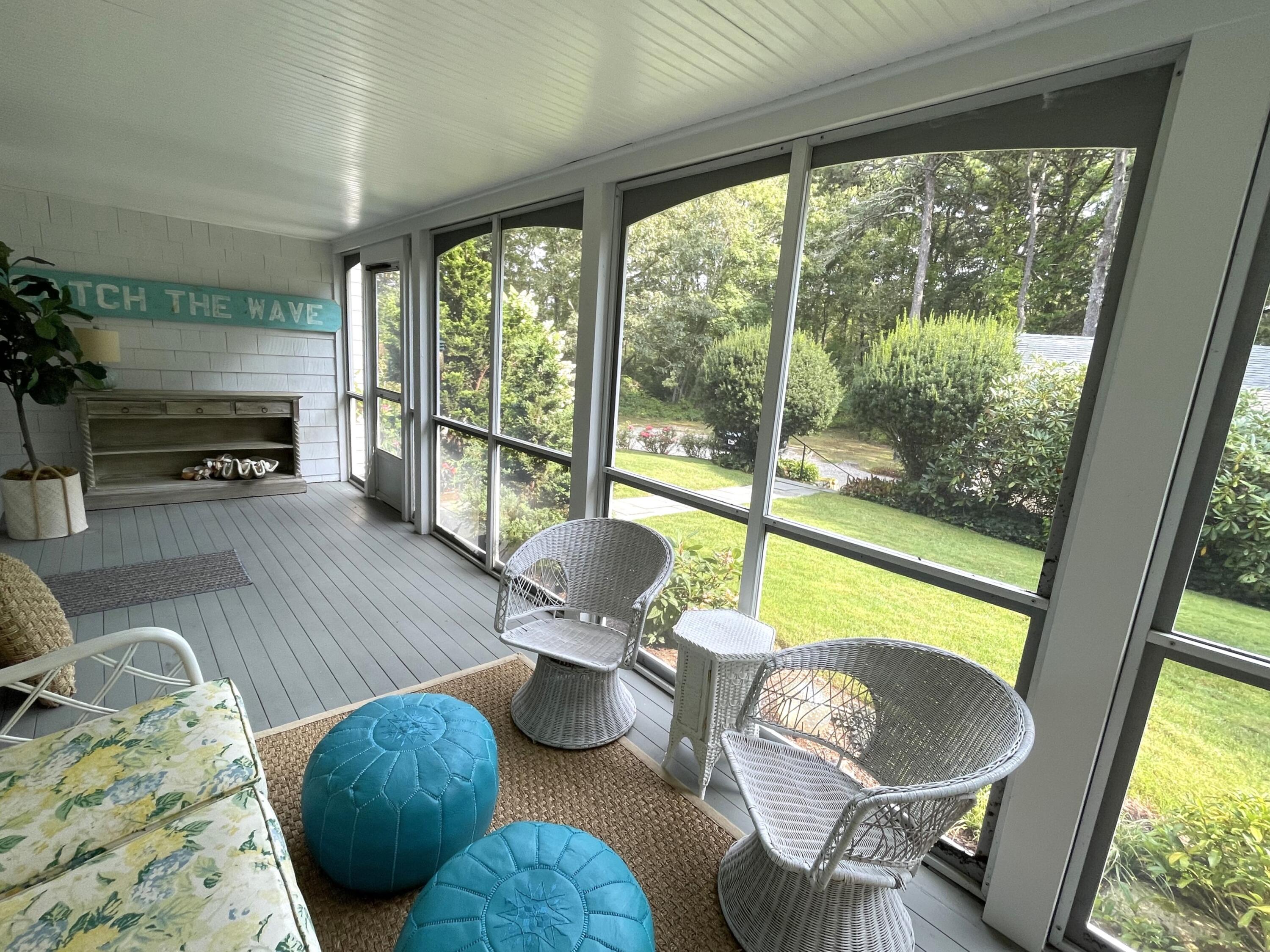100 Bay Lane Centerville, MA 02632 - Photo 22 of 32 a living room with furniture and a floor to ceiling window