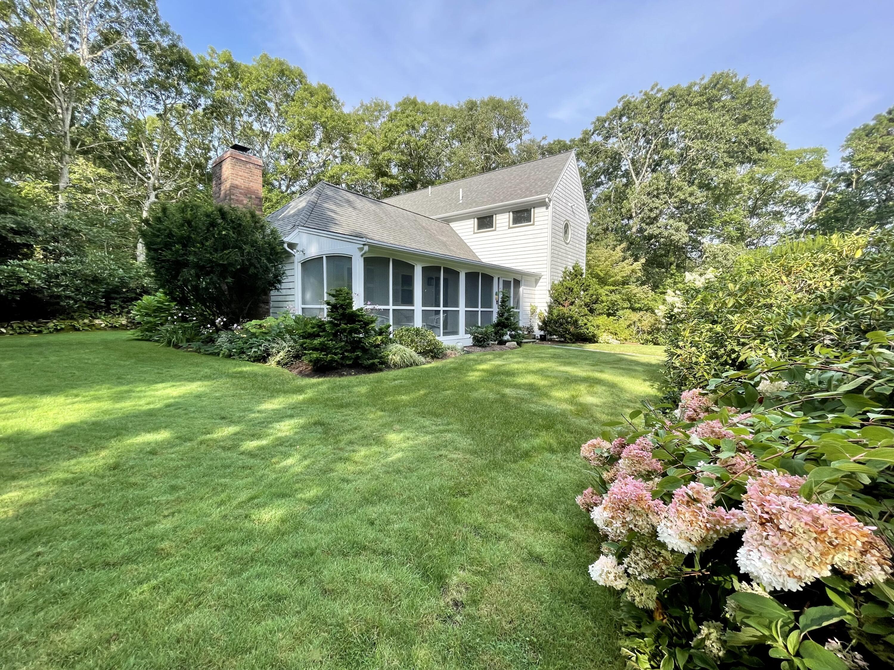 100 Bay Lane Centerville, MA 02632 - Photo 25 of 32 a front view of a house with a garden