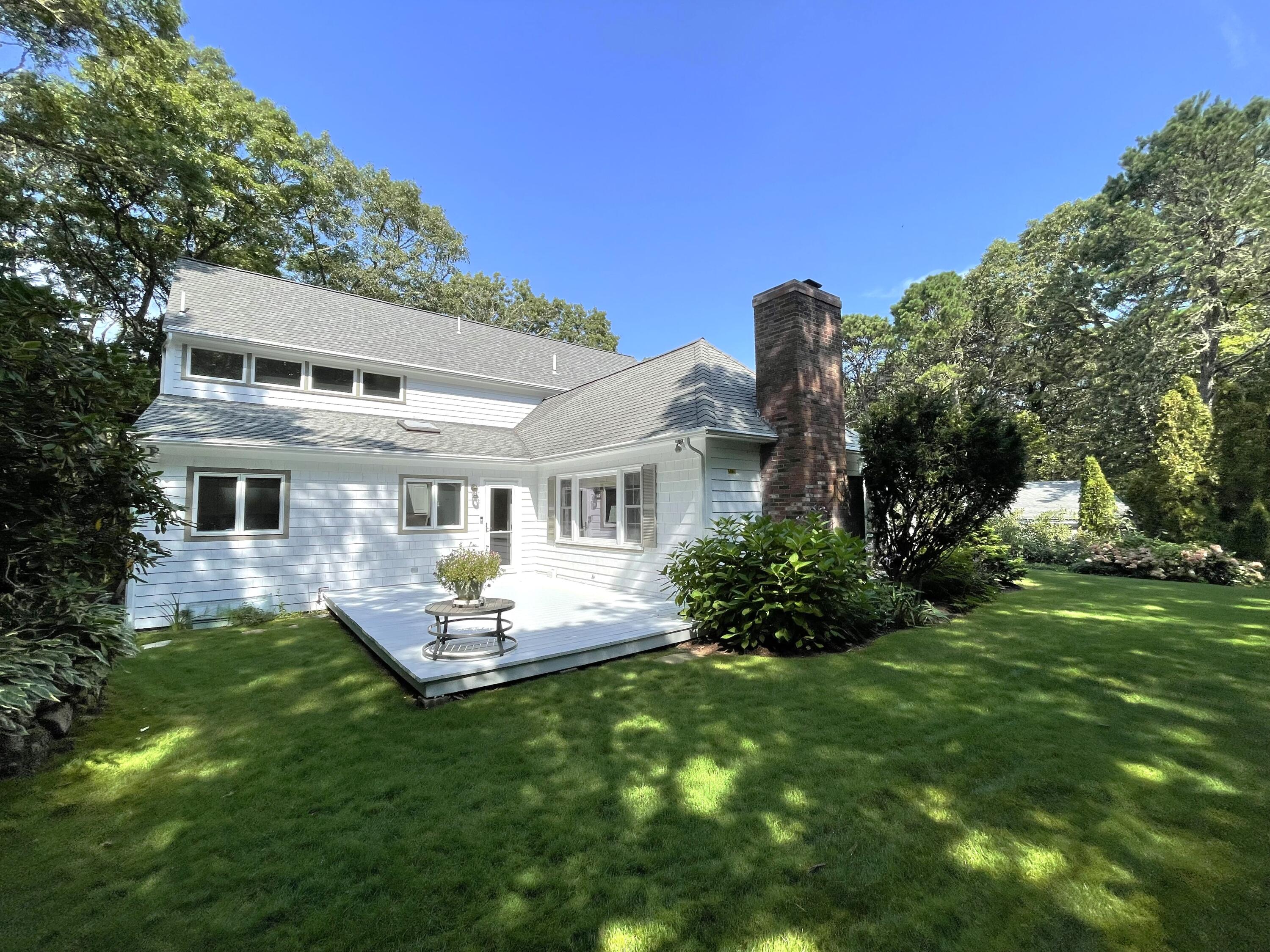 100 Bay Lane Centerville, MA 02632 - Photo 26 of 32 a front view of a house with a garden