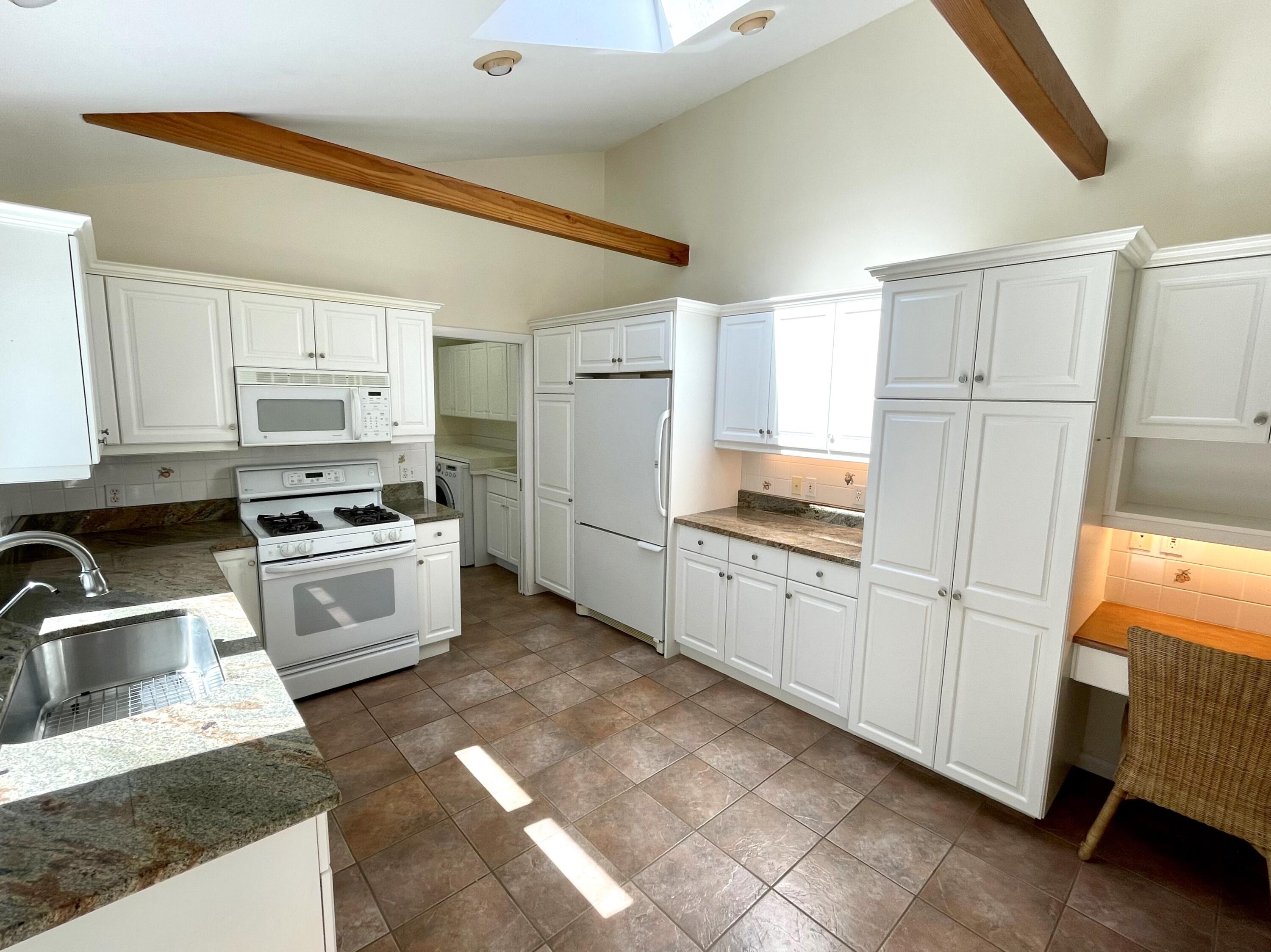 100 Bay Lane Centerville, MA 02632 - Photo 7 of 32 a kitchen with granite countertop white cabinets and white appliances