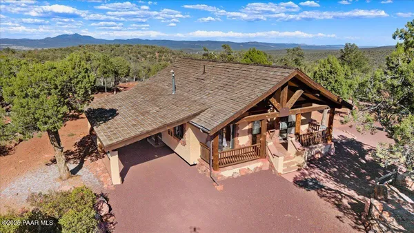 an aerial view of a house with a yard