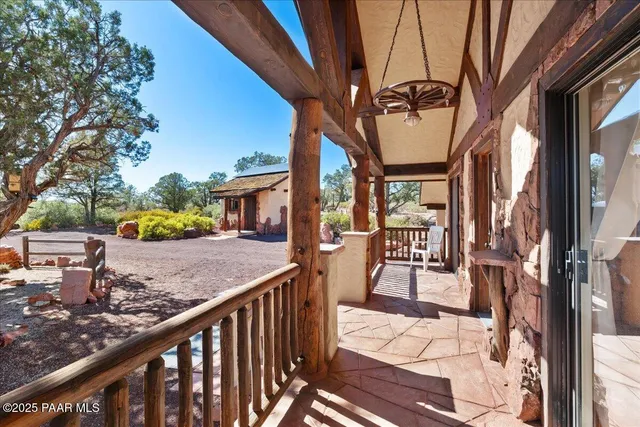 a view of a porch with furniture and a yard