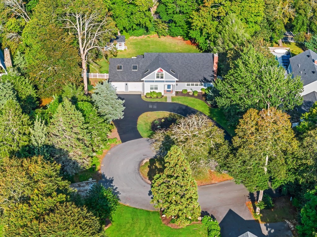 an aerial view of a house with a yard and garden