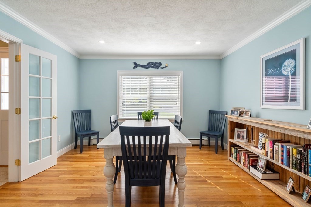 3 Nairn Road Bourne, MA 02559 - Photo 14 of 42 a dining room with furniture a book shelves and wooden floor