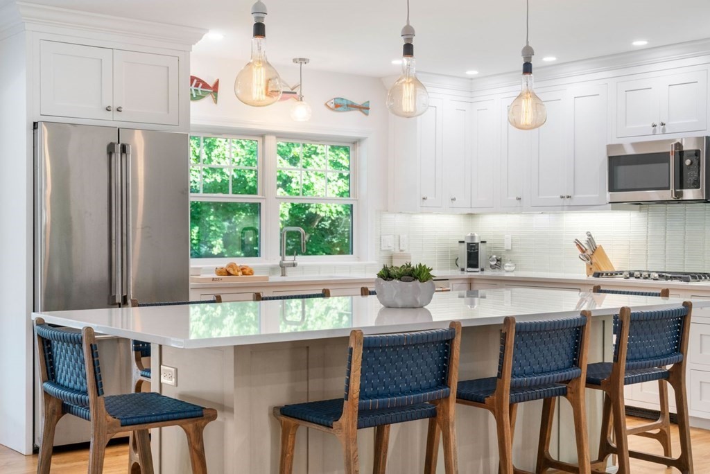 3 Nairn Road Bourne, MA 02559 - Photo 4 of 42 a kitchen with stainless steel appliances granite countertop a stove top oven a refrigerator a sink and chairs