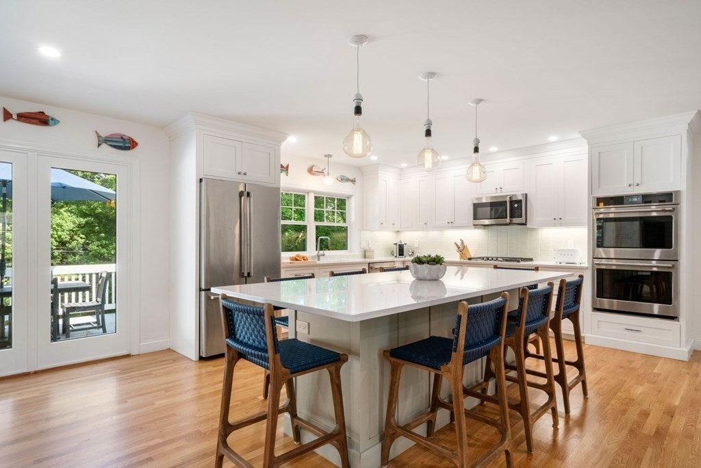 3 Nairn Road Bourne, MA 02559 - Photo 6 of 42 a kitchen with stainless steel appliances kitchen island a table and chairs in it