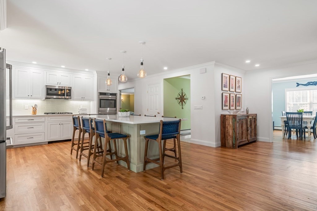3 Nairn Road Bourne, MA 02559 - Photo 8 of 42 a kitchen with stainless steel appliances a dining table chairs and wooden floor