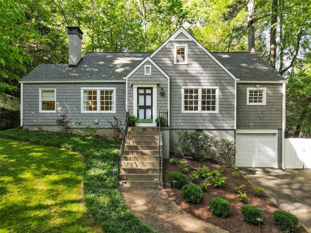 3788 Powers Ferry Road Northwest Atlanta, GA 30342 - Photo 1 of 1 a front view of a house with garden