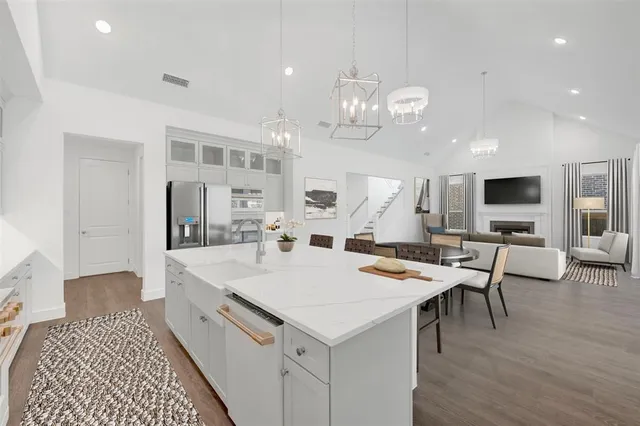 a large kitchen with a table and chairs