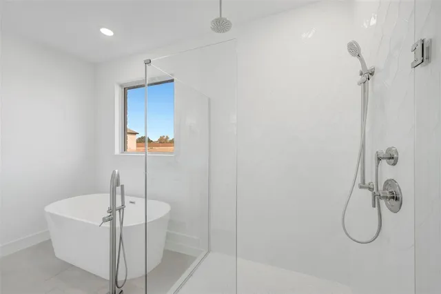 a bathroom with a bathtub and shower