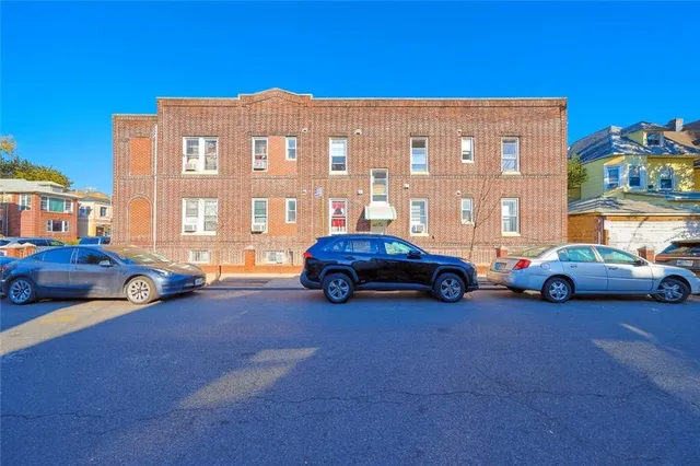 a view of cars parked in front of a building