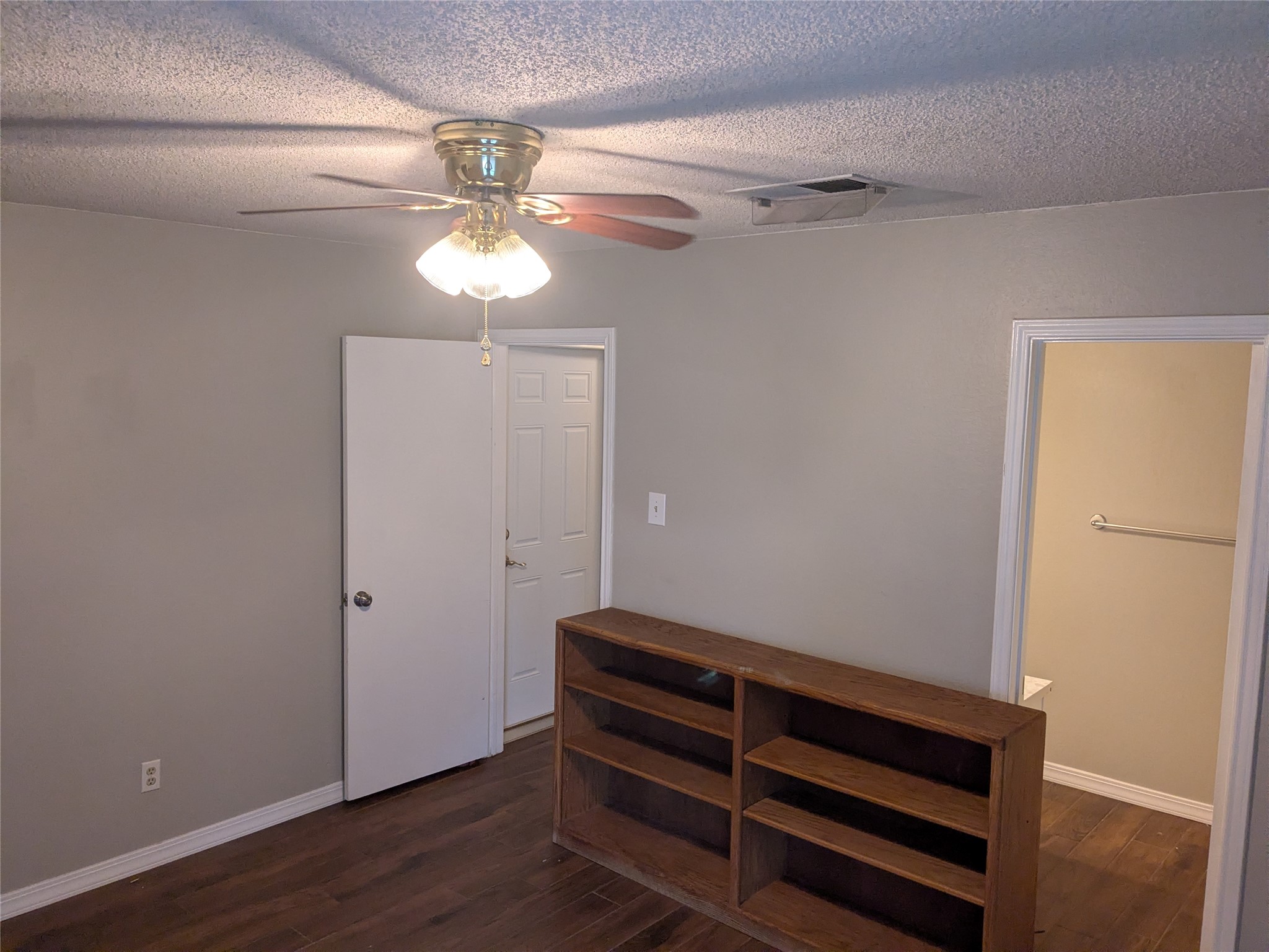 2502 Charla Circle Austin, TX 78728 - Photo 11 of 14 Hardwood-style flooring and a ceiling fan provide comfort in this generously sized bedroom space.