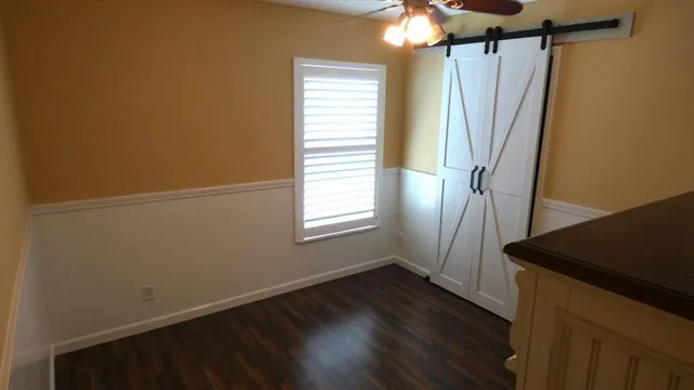 a bathroom with a granite countertop toilet sink and mirror