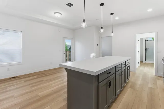 a view of a room with wooden floor and a window