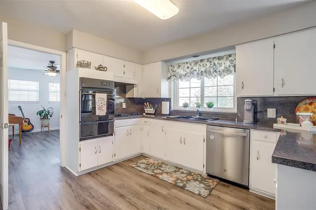 a kitchen with stainless steel appliances granite countertop a stove and a sink