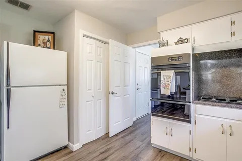 a kitchen with stainless steel appliances a refrigerator and a stove top oven