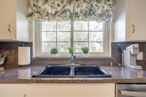 a kitchen with a sink and a window