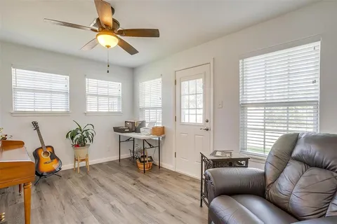 a living room with furniture and wooden floor