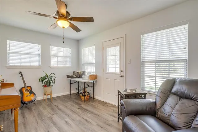a living room with furniture and wooden floor