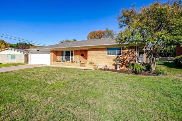 a front view of house with yard and green space